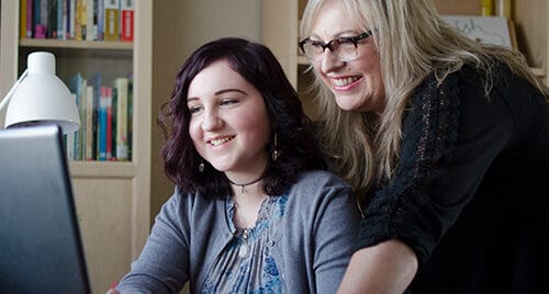 Mother and daughter doing homework at home